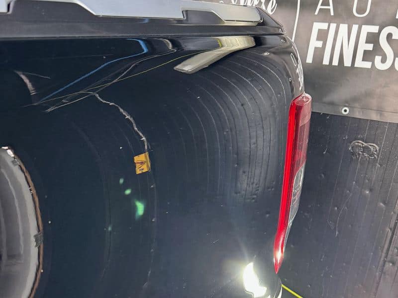 After: the same rear quarter of the black Ford Ranger after a machine polish and coating, with clear, deep reflections in the paint